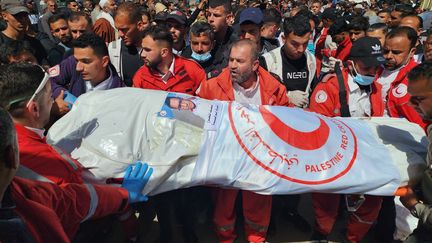 Des membres du Croissant-Rouge lors des obsèques d'un secouriste tué par les forces israéliennes, le 31 mars 2025 à Khan Younes, dans le sud de la bande de Gaza. (HANI ALSHAER / ANADOLU / AFP)